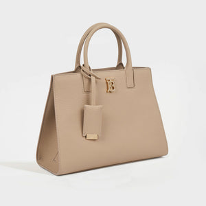 Side view of the BURBERRY Mini Frances Bag in Oat Beige Grainy Leather