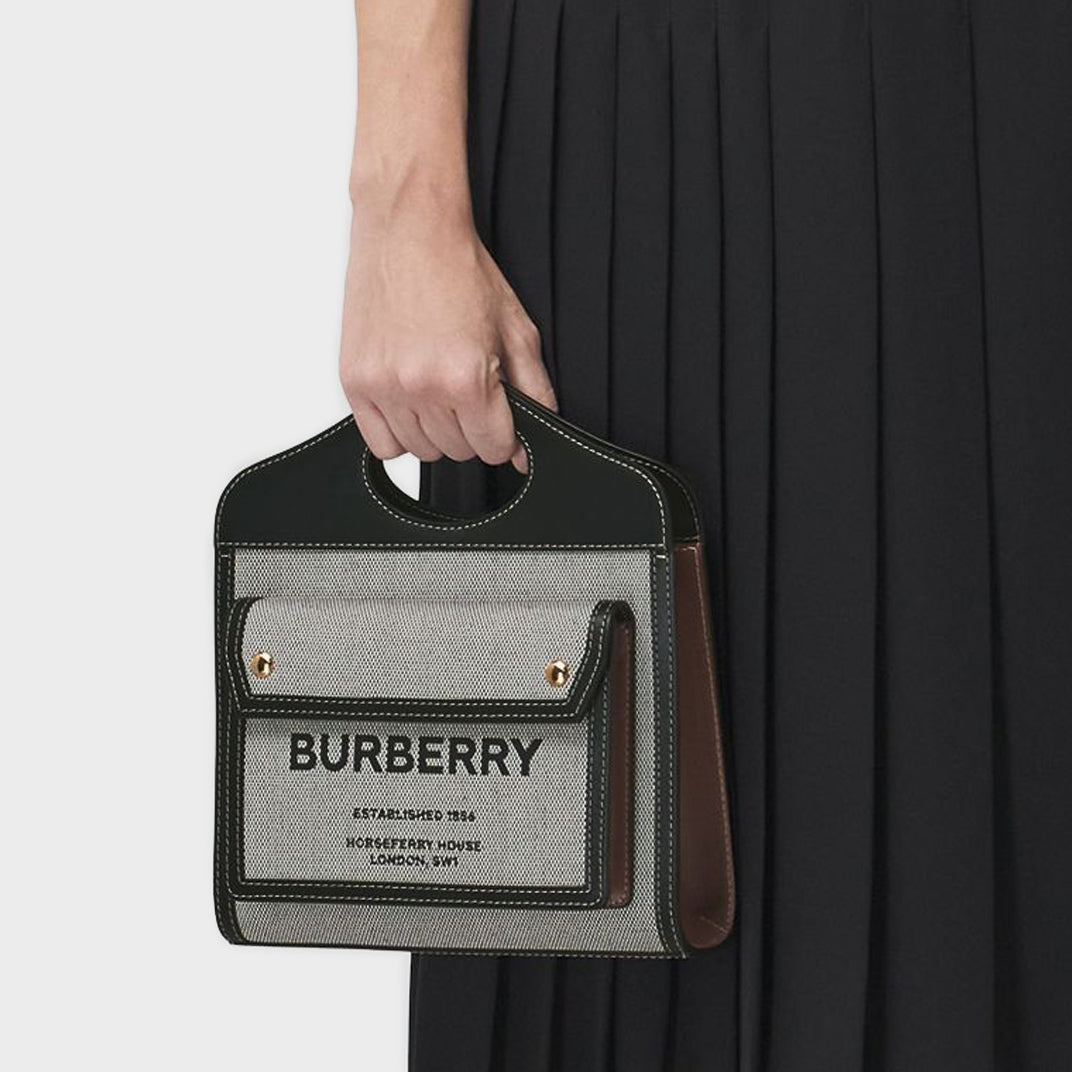 Model holding the BURBERRY Mini Tri-Colour Canvas & Leather Pocket Bag in Grey