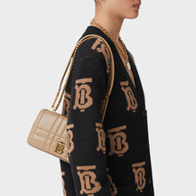 Load image into Gallery viewer, Model wearing a Burberry logo-cardigan and the BURBERRY Small Quilted Lola Bag in Oat Beige