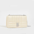 Side view of the BURBERRY Small Quilted Lola Bag in Pale Vanilla