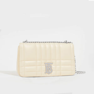Side view of the BURBERRY Small Quilted Lola Bag in Pale Vanilla