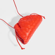 Load image into Gallery viewer, Top view of the BOTTEGA VENETA The Pouch 20 Intrecciato Crossbody in Bright Red - Rent a Bottga bag today