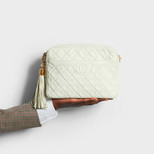 Load image into Gallery viewer, Model holding the CHANEL Vintage CC Diamond-Quilted Tassel Crossbody Bag in White