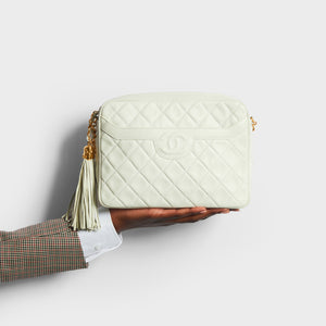 Model holding the CHANEL Vintage CC Diamond-Quilted Tassel Crossbody Bag in White
