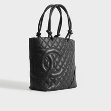 Load image into Gallery viewer, Side view of Chanel cambon ligne diamond quilted tote bag in black leather from 2003-2004