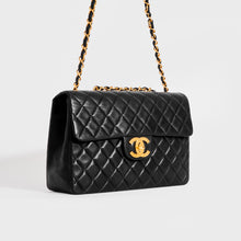 Load image into Gallery viewer, Side view of the CHANEL Large Single Flap Double Chain Bag in Black Lambskin 1994 - 1996