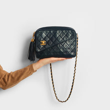 Load image into Gallery viewer, Model shot of the CHANEL Vintage CC Diamond Quilted Tassel Crossbody Bag in Navy 1991 - 1994