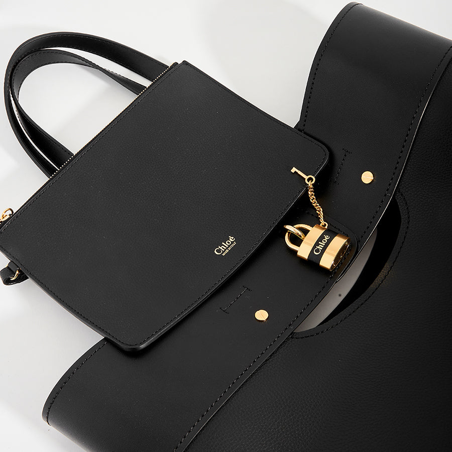 Small purse and lock detail on CHLOÉ Aby Large Smooth and Grained Leather Tote in Black