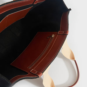 Inside view of Chloe large woody tote bag in black with tan leather detailing