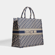 Load image into Gallery viewer, Side view of Dior Oblique Blue Book Tote Bag in Blue