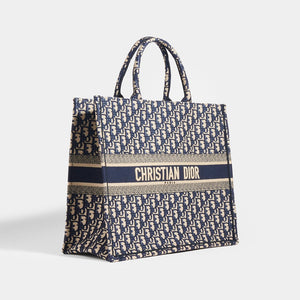 Side view of Dior Oblique Blue Book Tote Bag in Blue