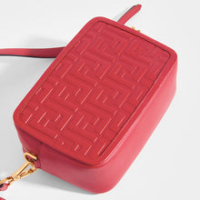 Load image into Gallery viewer, Close up of the FENDI Mini Camera Case Crossbody Bag in Red leather