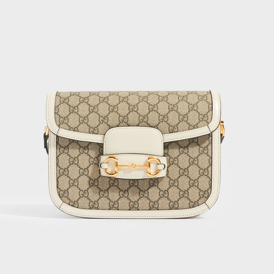 Front view of the GUCCI 1955 Horsebit Shoulder Bag in Coated GG Canvas with White Leather from front flap and horsebit gold hardware