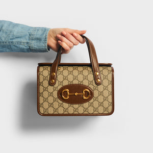 Model holding GUCCI 1955 Horsebit Mini Top Handle Bag