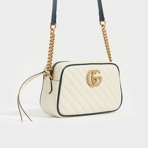 Side view of Gucci GG Marmont Camera Bag in White Leather with Navy Trim and Gold chain strap