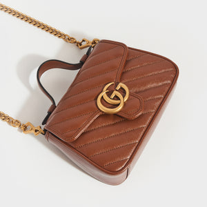 Top view of Gucci GG Marmont Mini Top Handle Bag in Brown Quilted Leather with gold chain strap