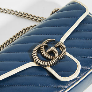 Close up of Gucci GG Marmont Small Shoulder Bag in Navy Matelasse Leather with White trim and silver chain strap