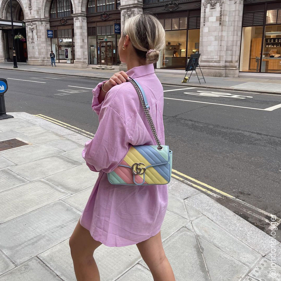 Woman with Gucci GG Marmont Small Shoulder Bag in Pink, Green, Yellow and Blue Pastel Striped Leather. Photo by @londonblogger