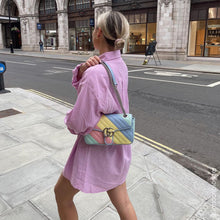 Load image into Gallery viewer, Woman with Gucci GG Marmont Small Shoulder Bag in Pink, Green, Yellow and Blue Pastel Striped Leather. Photo by @londonblogger