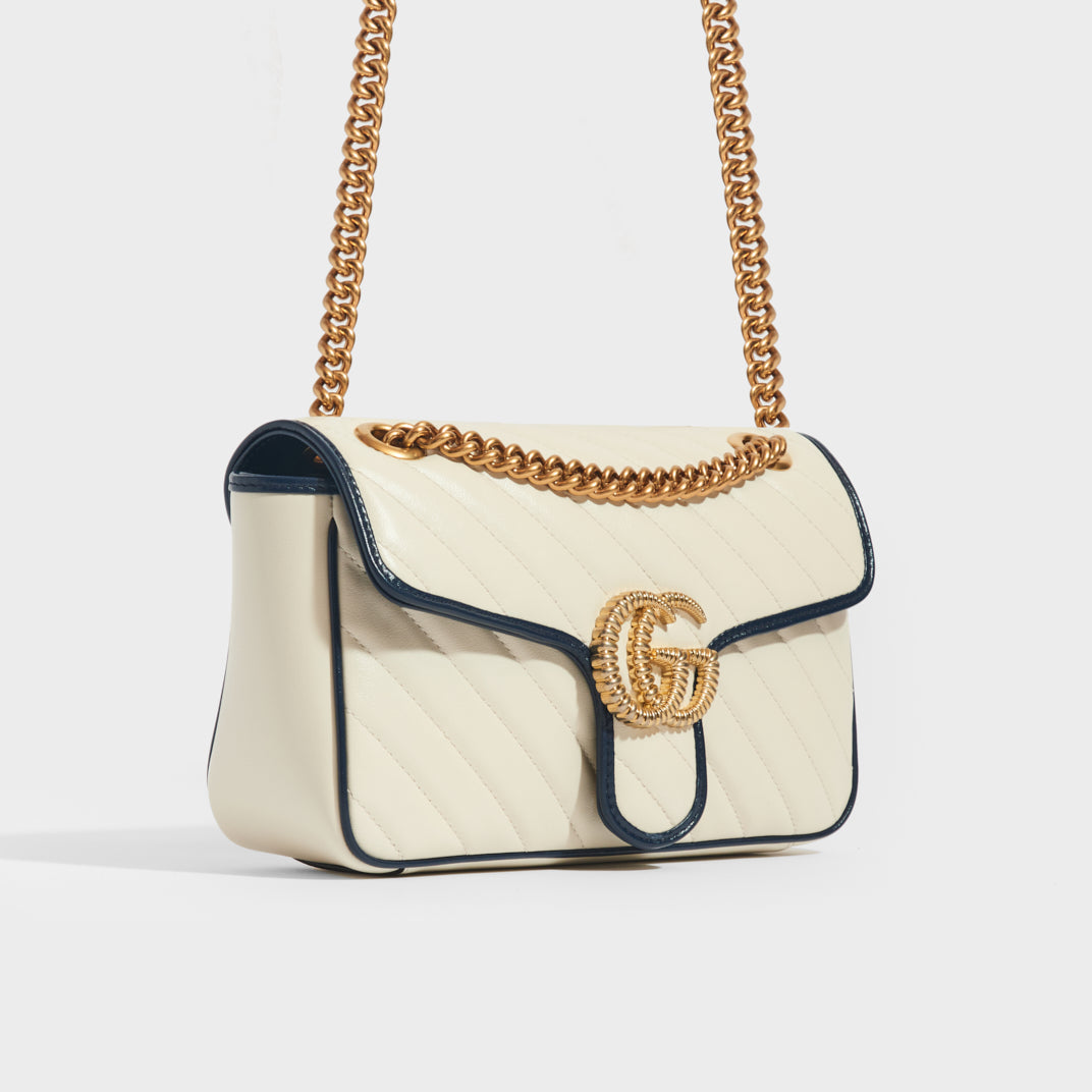 Side view of Gucci Marmont Small Shoulder Bag in White Leather with Navy Blue trim