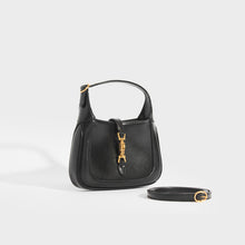Load image into Gallery viewer, Side view of the GUCCI Jackie 1961 Mini Hobo Bag in Black Leather