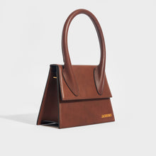Load image into Gallery viewer, Side view of the JACQUEMUS Le Grand Chiquito in Dark Brown