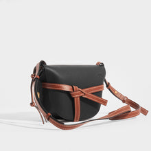 Load image into Gallery viewer, Side view of the LOEWE Gate Small Crossbody in Black with brown leather strap and time