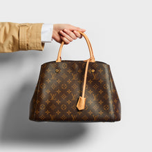 Load image into Gallery viewer, Model holding the LOUIS VUITTON Montaigne MM Tote in Monogram Canvas