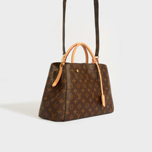 Load image into Gallery viewer, Side view of the LOUIS VUITTON Montaigne MM Tote in Monogram Canvas with detachable shoulder strap