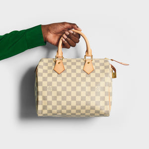 Model holding the LOUIS VUITTON Speedy 25 in Damier Azur Canvas 2012