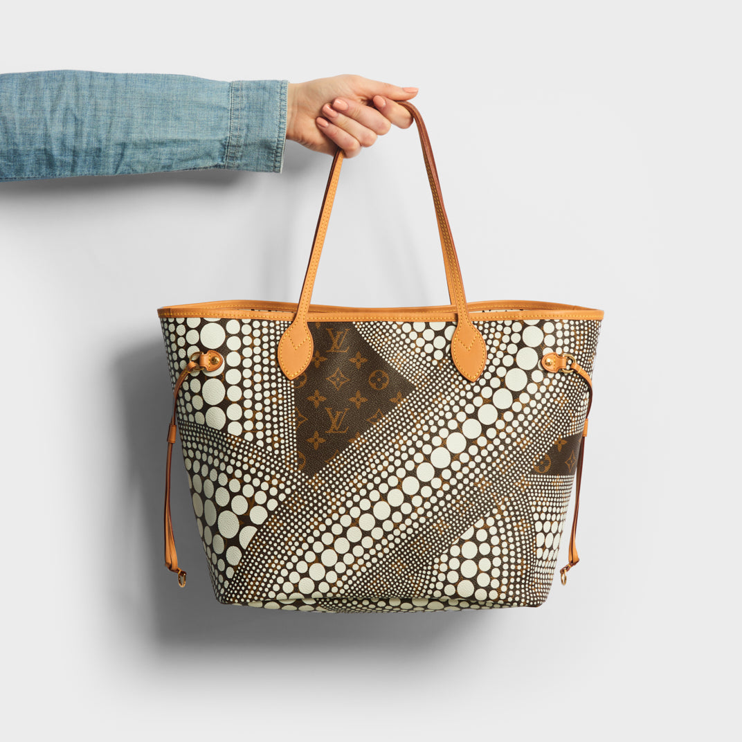 Model holding the LOUIS VUITTON x Yayoi Kusama Neverful MM Tote Bag 2012