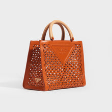 Load image into Gallery viewer, Side view of the PRADA Leather Cut Out Shopper with Wooden Handles in Papaya Orange