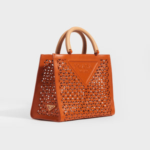 Side view of the PRADA Leather Cut Out Shopper with Wooden Handles in Papaya Orange
