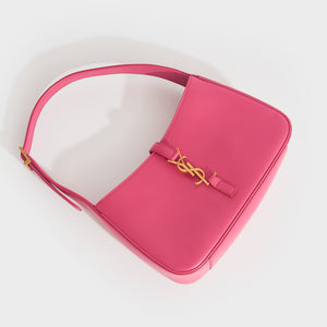 Flat shot of Saint Laurent Le 5 a 7 leather handbag in bubblegum pink with gold hardware