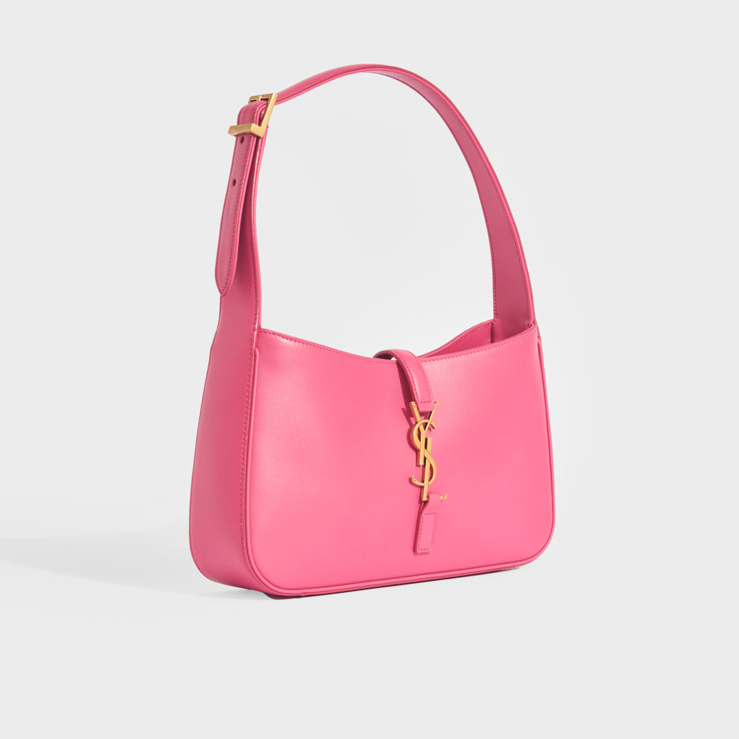 Side view of Saint Laurent Le 5 a 7 small leather handbag in bubblegum pink with gold hardware