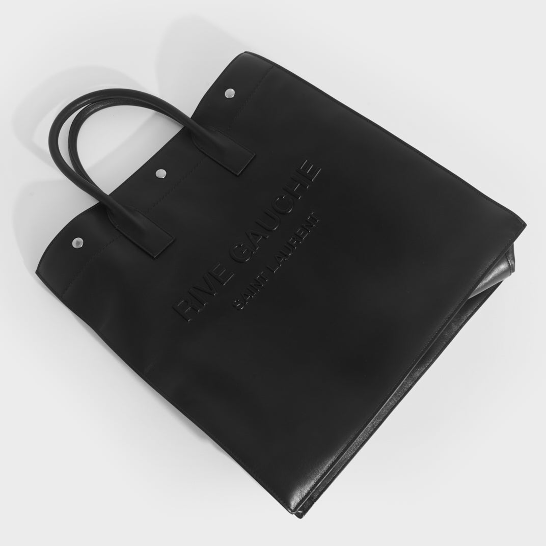 Flat shot of Saint Laurent Rive Gauche tote bag in black leather and silver hardware