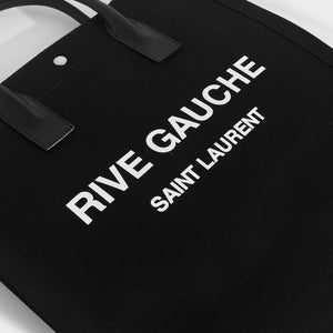 Close up of white printed logo on Rive Gauche Saint Laurent canvas tote bag in black 