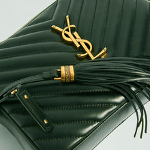 Load image into Gallery viewer, Close up detail of gold YSL hardware and leather tassel on the SAINT LAURENT Lou Camera Bag in Dark Green Matelassé Leather