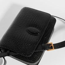 Load image into Gallery viewer, Top down detail view of the SAINT LAURENT Le 61 Framed Small Saddle Bag in Mock-Croc Leather in Black
