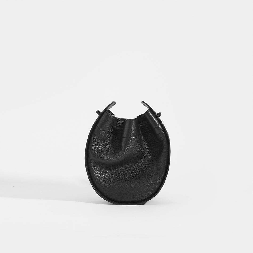 THE ROW Round Drawstring Leather Crossbody in Black Front View
