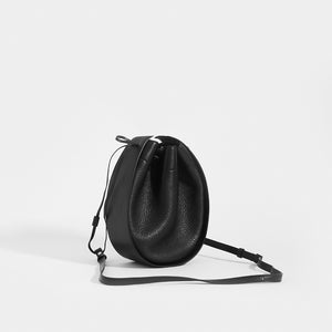 THE ROW Round Drawstring Leather Crossbody in Black