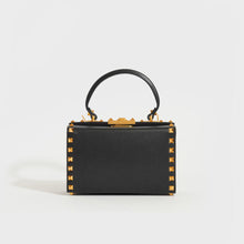 Load image into Gallery viewer, Front view of the VALENTINO Garavani Box Rockstud Alcove Leather Top Handle Bag in Black