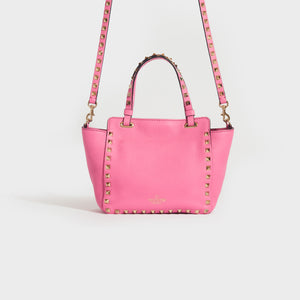 Rear view of the VALENTINO Garavani Mini Rockstud Leather Tote Bag in Dawn Pink