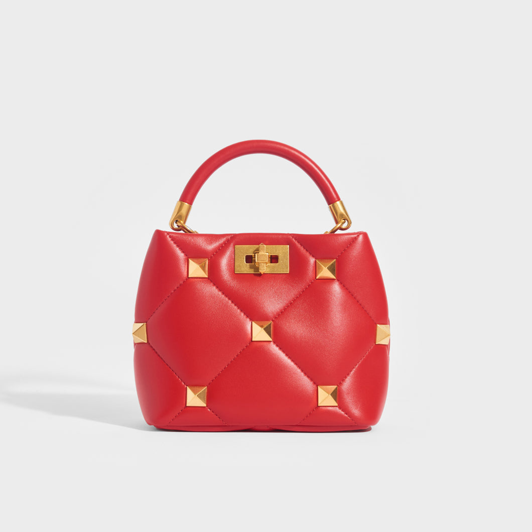 Front view of the VALENTINO Garavani Roman Stud Small Quilted Leather Tote in Red with Top Handle and Shoulder Strap 